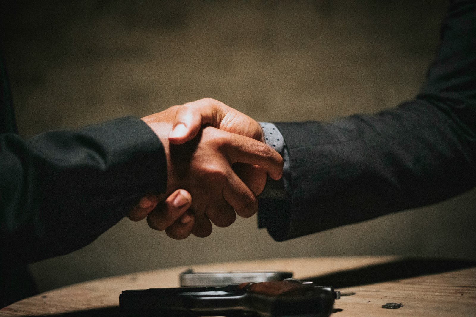 Investor meeting and handshake during a fundraising round supported by a CFO