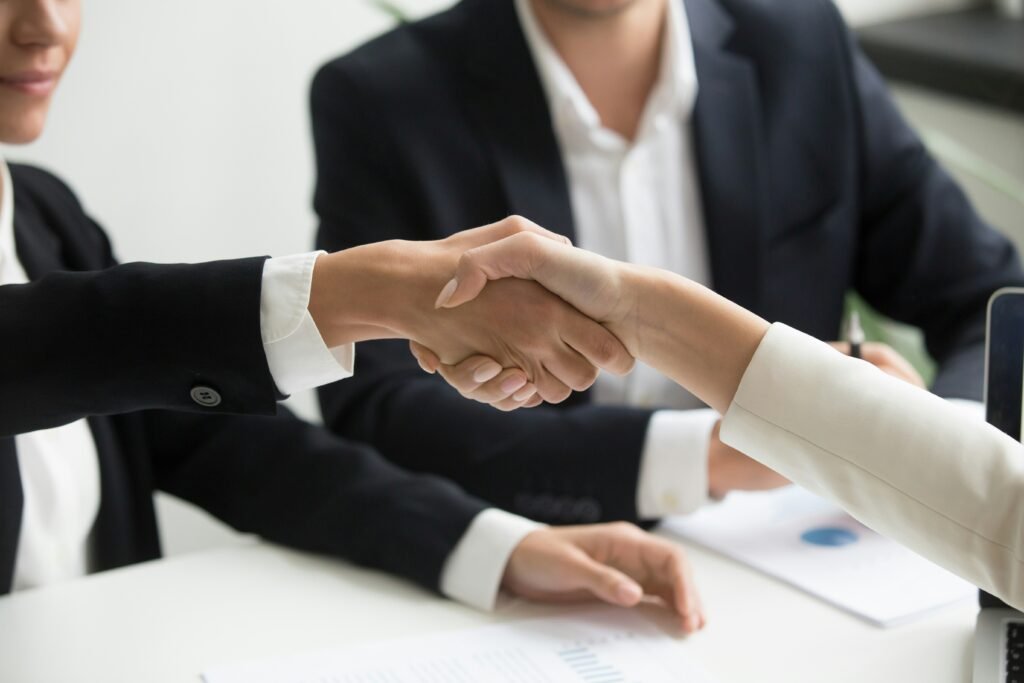Business handshake sealing an exit deal between founder and buyer